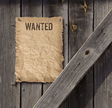 Wanted poster on weathered plank wood door