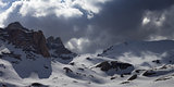 Panoramic view on snowy mountains in storm clouds