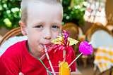 5 years old boy drinking a delicious fruit cocktail
