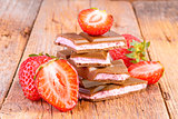 chocolate with strawberry cream on wooden