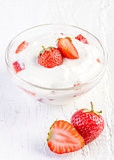 fresh organic yogurt with strawberries on wooden