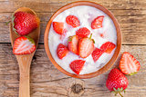 fresh organic greek yogurt with strawberries on wooden 