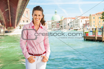 Happy, relaxed woman tourist standing near Grand Canal in Venice