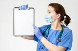Doctor pointing at blank clipboard