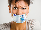 Covering mouth with a euro banknote