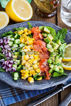 Salmon, avocado, corn, cucumber and onion salad