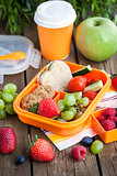 Lunch box for kids with sandwich, cookies, fresh veggies and fruits