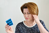 Adult woman taking a pill for  headache