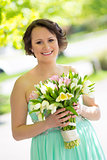 Happy bride with wedding bouquet.