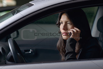 Woman driver sitting chatting on her mobile