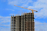 High-rise building under construction and crane 
