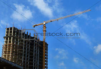 High-rise building under construction and crane 