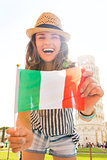 Laughing woman tourist holding Italian flag in Pisa