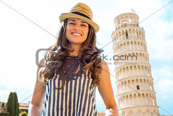 Happy female tourist smiling near Leaning Tower of Pisa