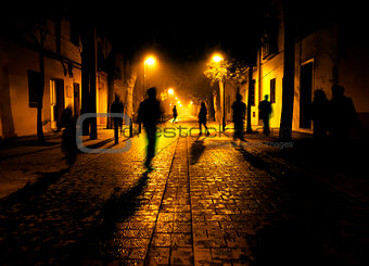 Shadows of people walking down the street