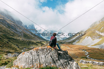 A man in front of a mountainous landscape