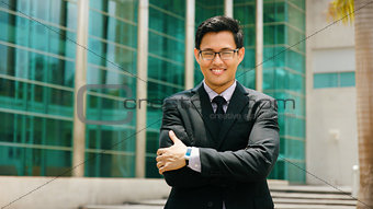 Portrait Chinese Businessman With Arms Crossed Smiling Outside O