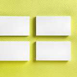 Blank business cards on green background.