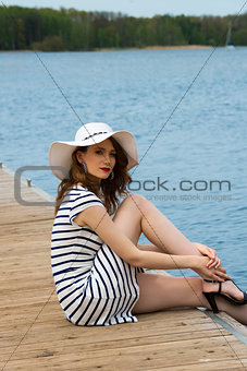girl on jetty near lake 
