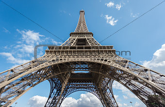 The Eiffel Tower over blue sky, bottom-up view