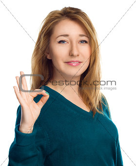 Young woman is showing OK sign, isolated over white 