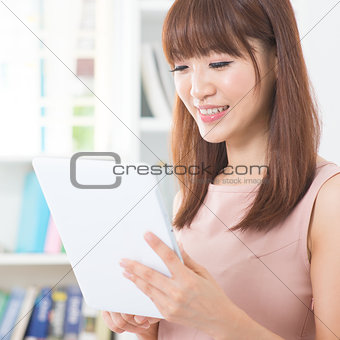 Asian girl using tablet