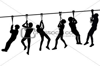 Silhouettes of children playing with a tyrolean traverse