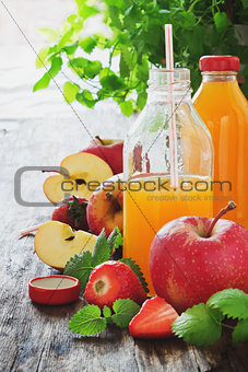 fruit juice, ripe apples and strawberries