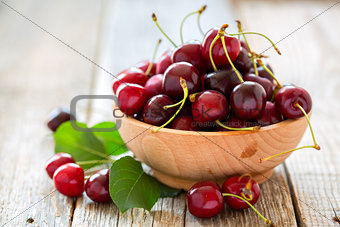 Wooden bowl with ripe cherries.