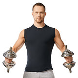 Muscular bodybuilder guy doing exercises with dumbbells 
