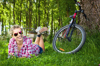 Young cyclist relaxation lying in the grass  