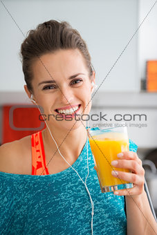 Smiling fit woman holding fresh juice in a glass