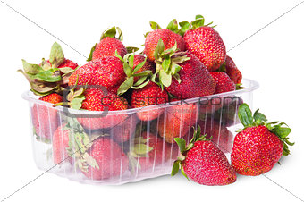 Freshly strawberries in a plastic tray and two near rotated