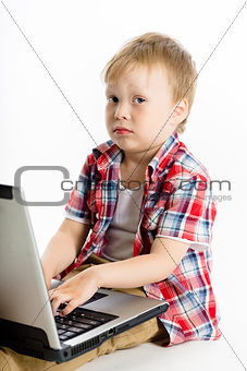 child with a laptop. studio