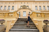 rich girl in blue near a big palace