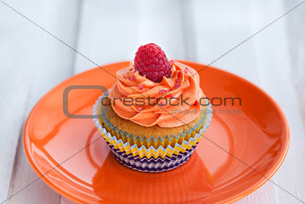 Delicious cream and raspberry cupcake