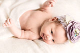 Portrait of newborn baby girl  with  headband 