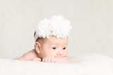 Portrait of newborn baby girl  with white headband 