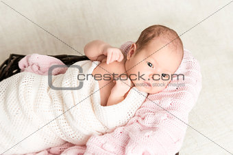 Newborn baby laying in the basket
