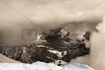 Sepia snowy mountains in clouds