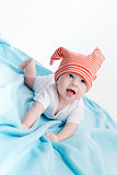 Baby in hat lying