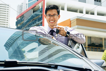 Happy Young Asian Man Smiling Showing Keys Of New Car