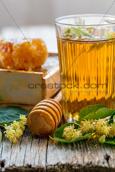 Linden tea in a glass and honey.
