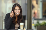Woman savoring a tasty cup of cappuccino coffee