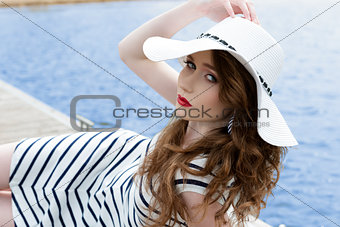 charming girl lying near sea 
