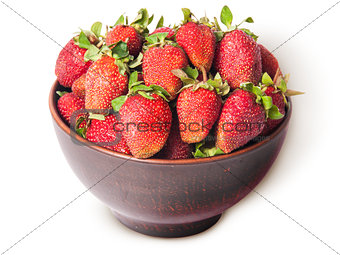 Ripe juicy strawberries in a ceramic bowl top view