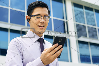 Businessman Talking Video Call On Mobile With Bluetooth Handsfre