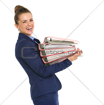 Smiling businesswoman in profile holding stack of files