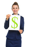 Happy businesswoman holding up sheet of paper with dollar sign