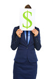 Businesswoman holding dollar sign in front of face